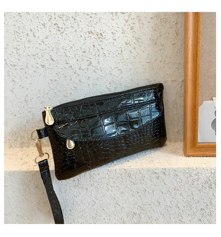 Model holding Bodhi Bag – minimalist PU wallet clutch with zipper closure and sequined sparkle finish by Vespera The Label