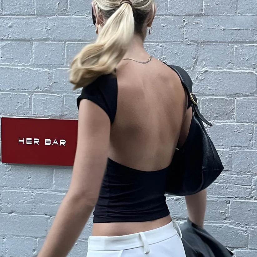 Model wearing Ciello Top – sleek purple crop shirt for women with stretch fit, ideal as a bold summer top from Vespera The Label.