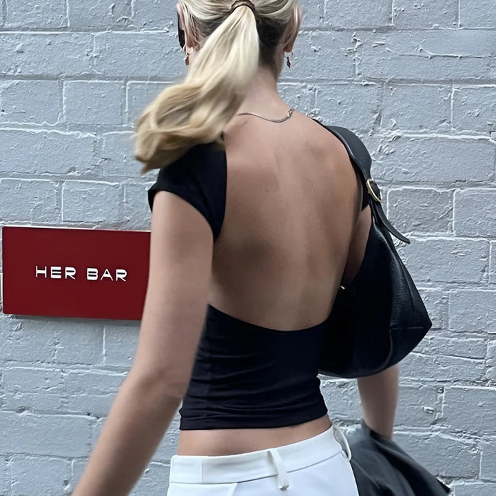 Model wearing Ciello Top – sleek purple crop shirt for women with stretch fit, ideal as a bold summer top from Vespera The Label.