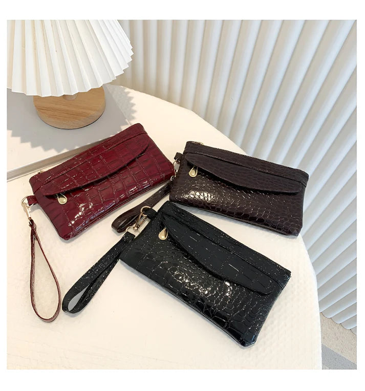Model holding Bodhi Bag – minimalist PU wallet clutch with zipper closure and sequined sparkle finish by Vespera The Label