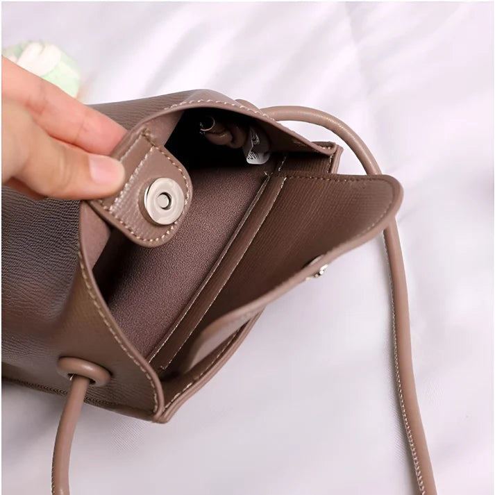 Model wearing Felly Bag – minimalist PU leather shoulder bag with hasp closure and smooth finish, by Vespera The Label