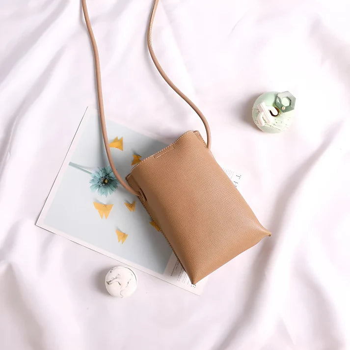 Model wearing Felly Bag – minimalist PU leather shoulder bag with hasp closure and smooth finish, by Vespera The Label