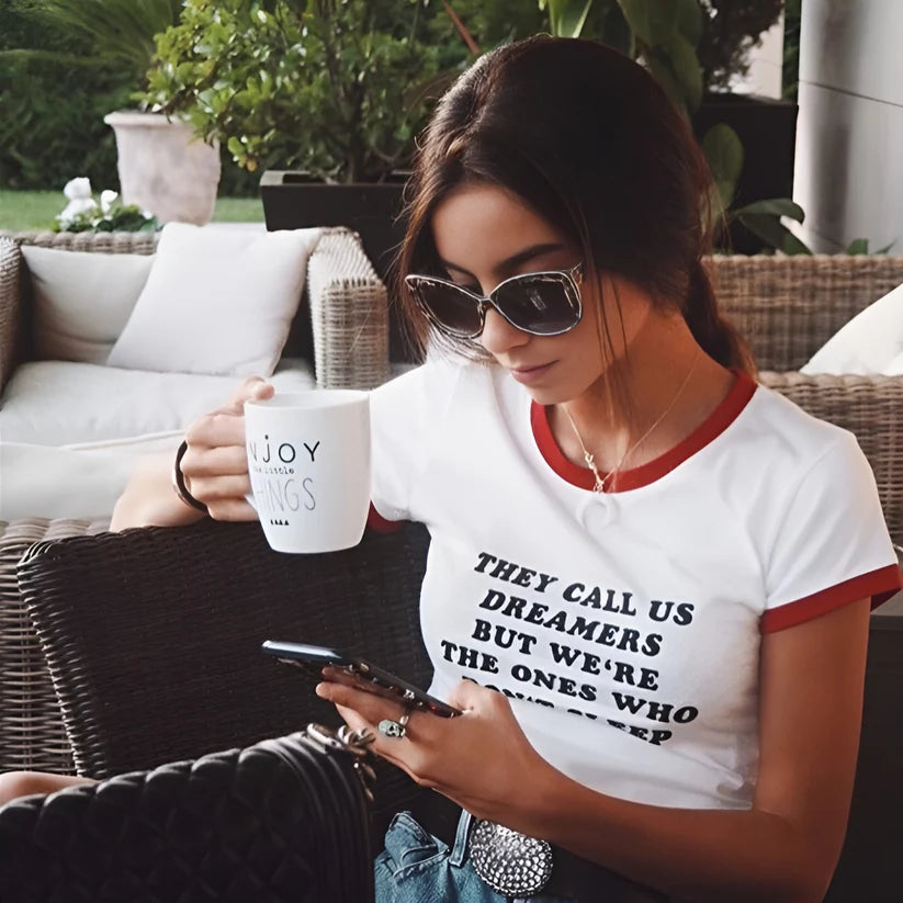 Model wearing Dreamers Top – graphic slogan crop top for women with a fitted cut and bold text print by Vespera The Label.