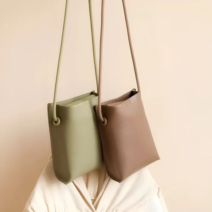 Model wearing Felly Bag – minimalist PU leather shoulder bag with hasp closure and smooth finish, by Vespera The Label