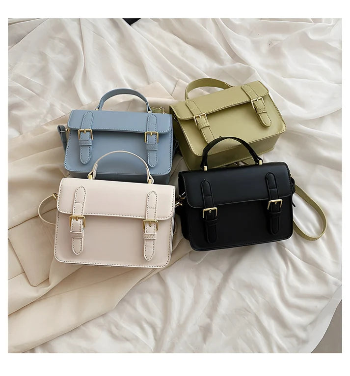 Model holding Ishna Bag – minimalist PU leather clutch with flap pocket and hasp closure in compact structured silhouette by Vespera The Label