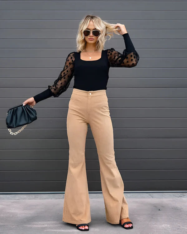 Model wearing Sheena Pants – full-length flare trousers with slim fit and mid-rise cut, styled for winter wear by Vespera The Label