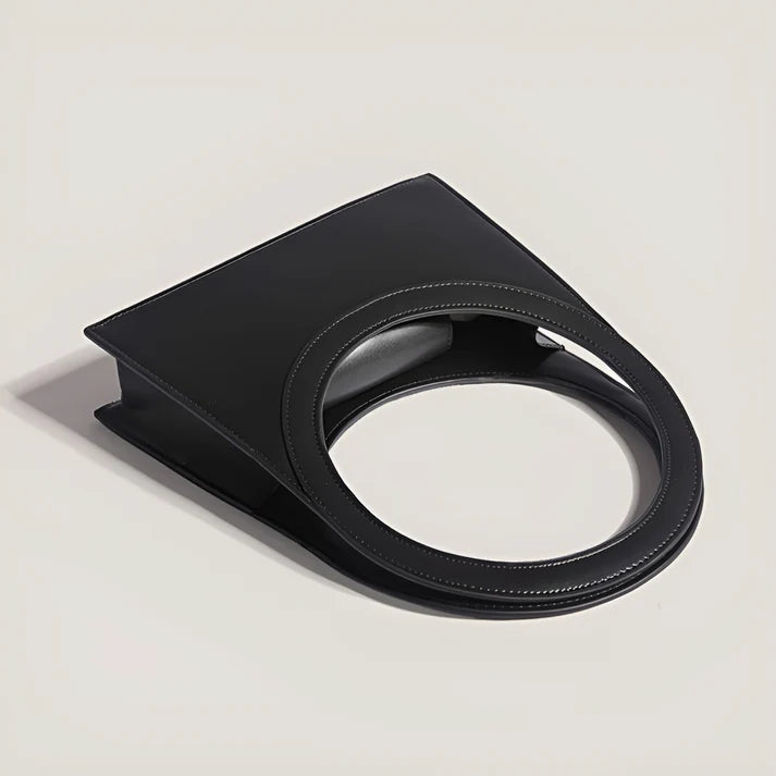 Model holding Miriah Bag – compact PU leather handbag with ring handle, high-end finish, and minimalist motorcycle-inspired design by Vespera The Label