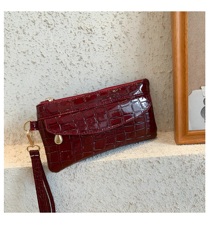 Model holding Bodhi Bag – minimalist PU wallet clutch with zipper closure and sequined sparkle finish by Vespera The Label