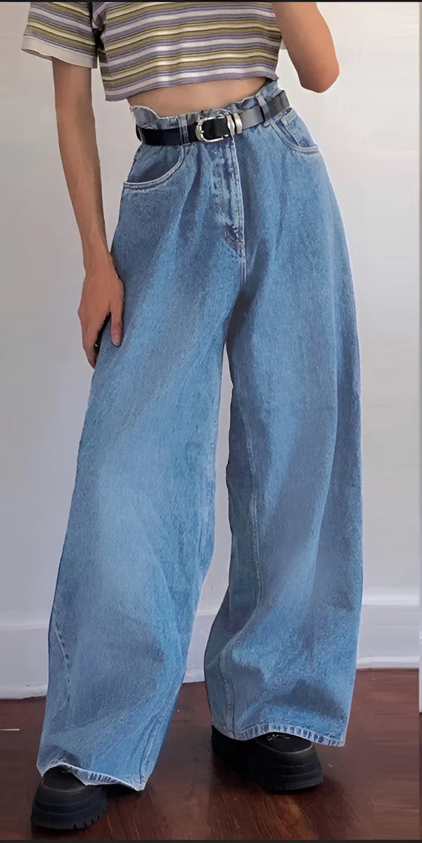 Model wearing Jeaney Pants – high-waisted ankle-length flared trousers with retro silhouette and spliced contrast detail by Vespera  The Label