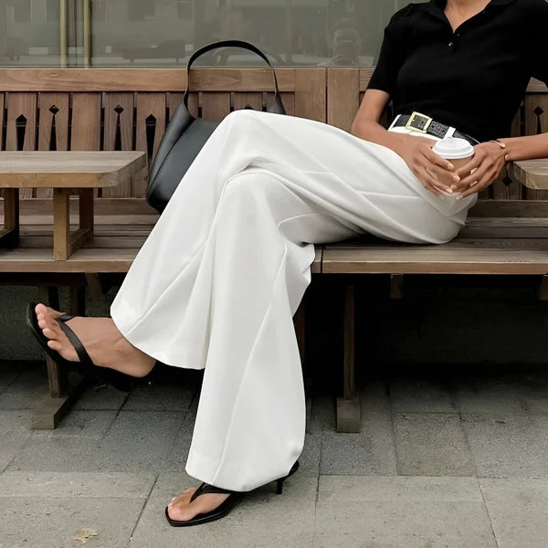Model wearing Fierra Pants – wide leg ankle-length office trousers in smooth polyester, by Vespera The Label