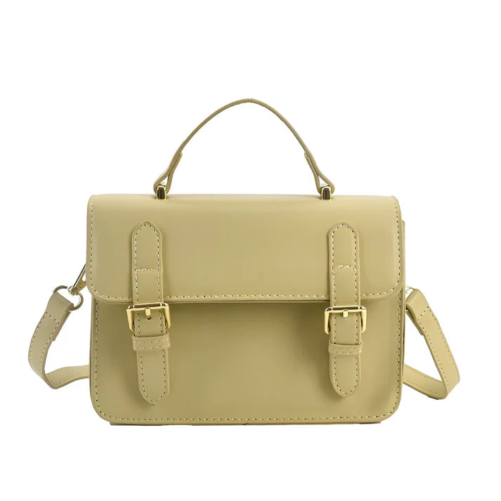 Model holding Ishna Bag – minimalist PU leather clutch with flap pocket and hasp closure in compact structured silhouette by Vespera The Label