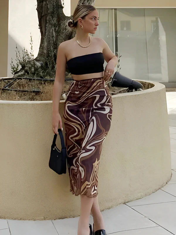Model wearing Jamaica Midi Skirt in abstract swirl print, styled with casual summer fashion top – Vespera The Label